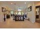 Open-concept living room with stylish decor, a view of the dining area, kitchen, and access to the outdoors at 603 Sanctuary Golf Pl, Apopka, FL 32712