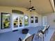 Covered patio featuring outdoor seating, a ceiling fan, and views of the surrounding landscape at 603 Sanctuary Golf Pl, Apopka, FL 32712