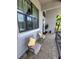 Cozy front porch with chairs, plants, and a view of the well-maintained exterior at 603 Sanctuary Golf Pl, Apopka, FL 32712