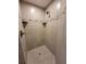 This is a tiled shower with a shower head and built-in shelving niche for storing bathroom products at 603 Sanctuary Golf Pl, Apopka, FL 32712
