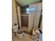 Bathroom showcasing a shower with tiled walls and floors, accented by a patterned shower curtain at 603 Sanctuary Golf Pl, Apopka, FL 32712