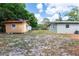 View of backyard with sheds and lawn of the home at 6124 Bear Lake Ter, Apopka, FL 32703