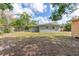 View of the home's backyard with lush grass at 6124 Bear Lake Ter, Apopka, FL 32703