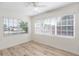 Bedroom featuring new floors, ceiling fan, and natural light through multiple windows at 6124 Bear Lake Ter, Apopka, FL 32703