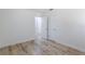 Bright bedroom features wood-look flooring and doorways with white trim throughout at 6124 Bear Lake Ter, Apopka, FL 32703