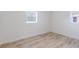 Bright bedroom features wood-look flooring and two windows bringing in natural light at 6124 Bear Lake Ter, Apopka, FL 32703