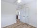 Bright bedroom features wood-look flooring, ceiling fan, and a closet with double doors for ample storage at 6124 Bear Lake Ter, Apopka, FL 32703