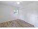 Bright bedroom featuring a ceiling fan, wood-look flooring and a double-door closet at 6124 Bear Lake Ter, Apopka, FL 32703