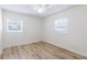 Bright bedroom features wood-look flooring and two windows bringing in plenty of natural light at 6124 Bear Lake Ter, Apopka, FL 32703
