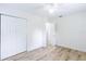 Bright bedroom featuring a double-door closet and wood-look flooring throughout at 6124 Bear Lake Ter, Apopka, FL 32703