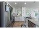 Bright kitchen features white cabinetry, granite counters, and stainless appliances at 6124 Bear Lake Ter, Apopka, FL 32703