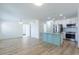 Bright, open-concept living area with a kitchen island and new wood flooring at 6124 Bear Lake Ter, Apopka, FL 32703