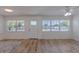 Inviting living room featuring new floors, a front door, and bright windows at 6124 Bear Lake Ter, Apopka, FL 32703