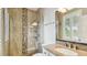 Bathroom featuring a glass shower, neutral walls, granite countertop and vanity with a framed mirror at 616 Grand Cypress Pt, Sanford, FL 32771