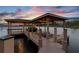 Well-maintained boat dock featuring sturdy construction, ample covered space, and easy access to the serene lake at 616 Grand Cypress Pt, Sanford, FL 32771