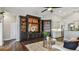 Inviting living room featuring a built-in entertainment center, hardwood floors, and stylish decor at 616 Grand Cypress Pt, Sanford, FL 32771