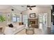 Cozy living room featuring a brick fireplace, neutral decor, and panoramic views of the lake at 616 Grand Cypress Pt, Sanford, FL 32771