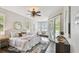 Bright main bedroom features a ceiling fan, neutral walls, a sitting area and access to the back patio at 616 Grand Cypress Pt, Sanford, FL 32771