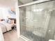 Clean bathroom with glass shower door and convenient access to the bedroom area at 6165 Carrier Dr # 2308, Orlando, FL 32819