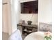The storage console features cabinet and shelf storage, decor and a large television at 6165 Carrier Dr # 2308, Orlando, FL 32819