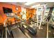Well-equipped gym featuring modern exercise machines, weights, and wall mounted TV at 6165 Carrier Dr # 2308, Orlando, FL 32819