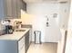 Compact kitchen features stone countertops, essential appliances and easy access to front door at 6165 Carrier Dr # 2308, Orlando, FL 32819