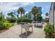 Outdoor recreation area with games, tables, lush greenery, and beautiful landscaping at 6165 Carrier Dr # 2308, Orlando, FL 32819