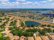 Aerial view of a community with lakes and houses, highlighting the neighborhood's serene setting at 6550 Crestmont Glen Ln, Windermere, FL 34786
