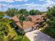 Aerial view of a single-Gathering house, showcasing the roof, driveway, and mature landscaping at 6550 Crestmont Glen Ln, Windermere, FL 34786