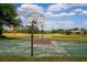 Community basketball court alongside a lake, providing a great space for outdoor recreation and exercise at 6550 Crestmont Glen Ln, Windermere, FL 34786