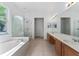 Spacious bathroom featuring dual sinks, vanity, soaking tub, and glass enclosed shower at 6550 Crestmont Glen Ln, Windermere, FL 34786