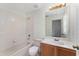 A clean bathroom with a shower-tub combo, toilet, and vanity with lighting at 6550 Crestmont Glen Ln, Windermere, FL 34786