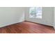 Comfortable bedroom with hardwood floors and a large window providing serene backyard views at 6550 Crestmont Glen Ln, Windermere, FL 34786