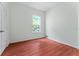 This bedroom features a window bringing in tons of natural light and laminate wood flooring at 6550 Crestmont Glen Ln, Windermere, FL 34786