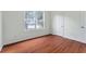 Inviting bedroom with hardwood floors and a scenic view of the lake at 6550 Crestmont Glen Ln, Windermere, FL 34786