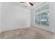Bright, carpeted bedroom with a large window offering lots of natural light at 6550 Crestmont Glen Ln, Windermere, FL 34786