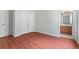 Bedroom with closet and bathroom, wood flooring, and neutral paint at 6550 Crestmont Glen Ln, Windermere, FL 34786
