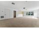 Large, carpeted bonus room with natural light from windows and offering views of the front yard at 6550 Crestmont Glen Ln, Windermere, FL 34786
