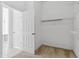 Empty walk-in closet showing access to storage shelves and access to the bathroom at 6550 Crestmont Glen Ln, Windermere, FL 34786
