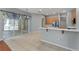 Open dining area with sliding glass doors, tiled floors, and seamless connection to kitchen at 6550 Crestmont Glen Ln, Windermere, FL 34786