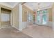 Spacious foyer with decorative glass doors, tiled floor, and elegant lighting fixture at 6550 Crestmont Glen Ln, Windermere, FL 34786