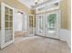 Bright foyer features tile flooring, decorative glass double doors, and transom windows at 6550 Crestmont Glen Ln, Windermere, FL 34786