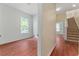 Hallway view with staircase and bedroom entrance; wood flooring and natural light at 6550 Crestmont Glen Ln, Windermere, FL 34786