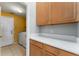 Bright laundry room with ample storage, white countertops, and a convenient washer and dryer setup at 6550 Crestmont Glen Ln, Windermere, FL 34786