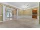 Open-concept living room with elegant chandelier, column details, and carpet floors at 6550 Crestmont Glen Ln, Windermere, FL 34786