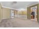 Spacious living room with neutral carpet, recessed lighting, and decorative trim at 6550 Crestmont Glen Ln, Windermere, FL 34786