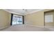 Large living room featuring carpet, fan, and sliding doors to the outside pool at 6550 Crestmont Glen Ln, Windermere, FL 34786