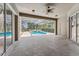 Enclosed patio with a ceiling fan, providing a comfortable view of the screened-in pool and backyard at 6550 Crestmont Glen Ln, Windermere, FL 34786