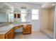 This bathroom features a large mirror and a tiled shower at 7700 Greytwig Ln, Orlando, FL 32818