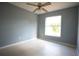 Cozy bedroom with neutral walls, tile flooring, and a bright window offering a peaceful retreat at 7700 Greytwig Ln, Orlando, FL 32818